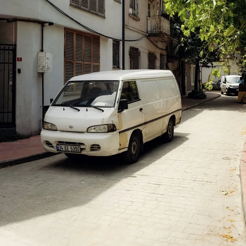 Our van waiting in a narrow lane outside a customer's gate
