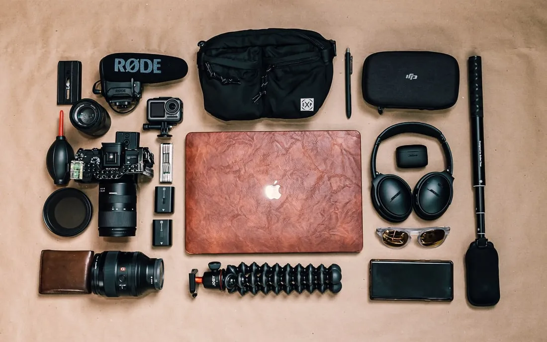 A photographer's kit — bodies, lenses, drives, headphones — laid out for its catalogue photo